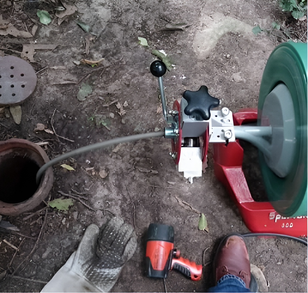 Plumber using CCTV drain camera to locate a blockage in a Redfern home