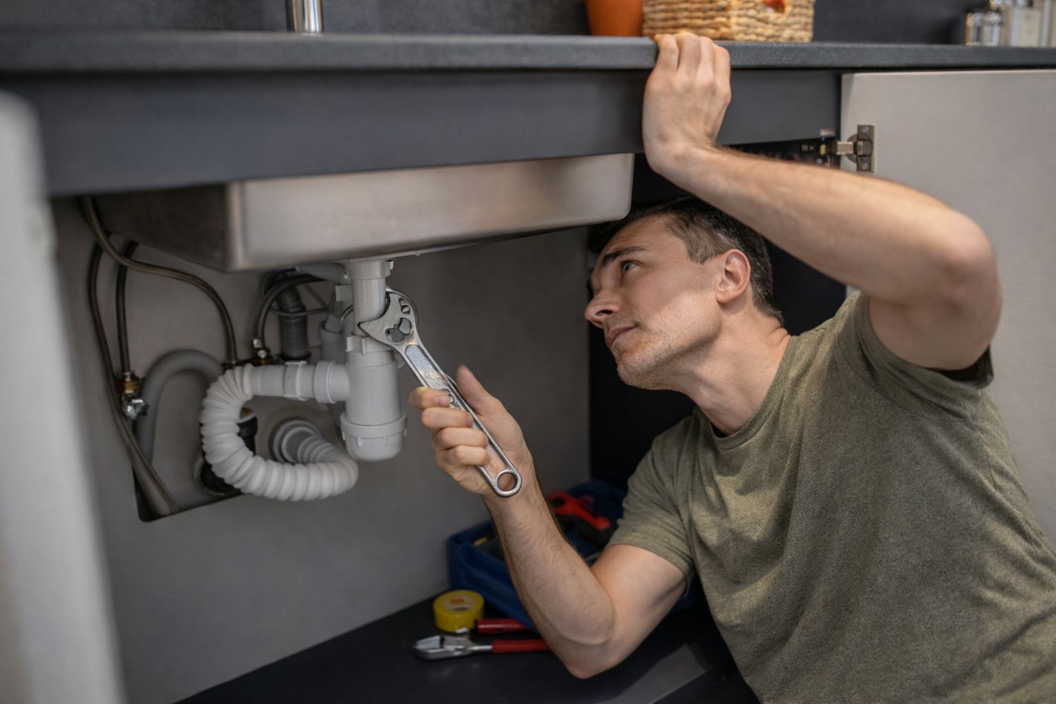 Homeowner attempting DIY plumbing repairs