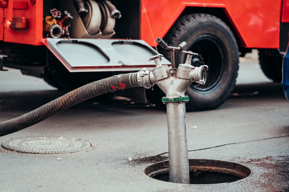 Technician clearing a blocked commercial drain using high-pressure jetting in Sydney