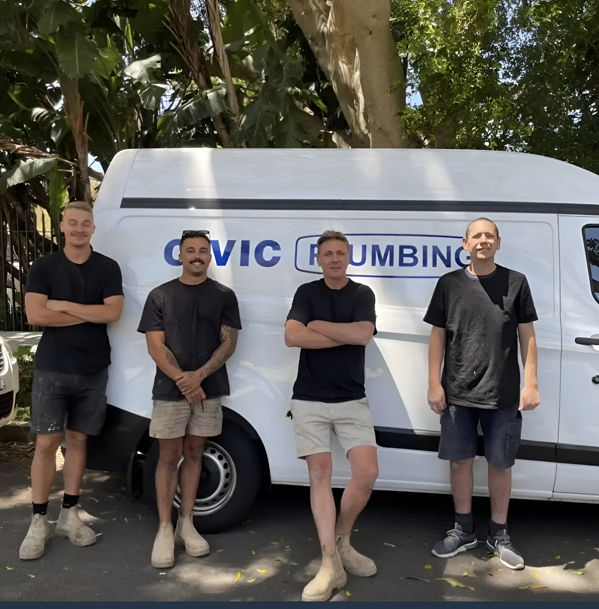 chris and team—trusted plumber in bondi—by civic plumbing van, wearing black shirts and shorts, sunny day.